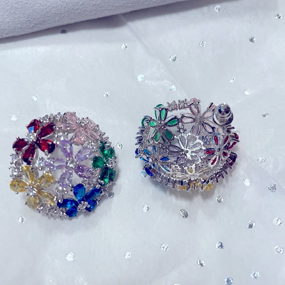 Lovely dome shaped earrings with multi colored glittering cubic zirconia stones.